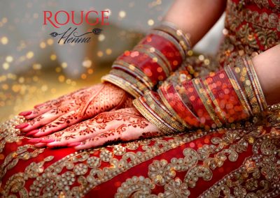 Gallery | Rouge Henna London | Bride in red dress with henna on hands